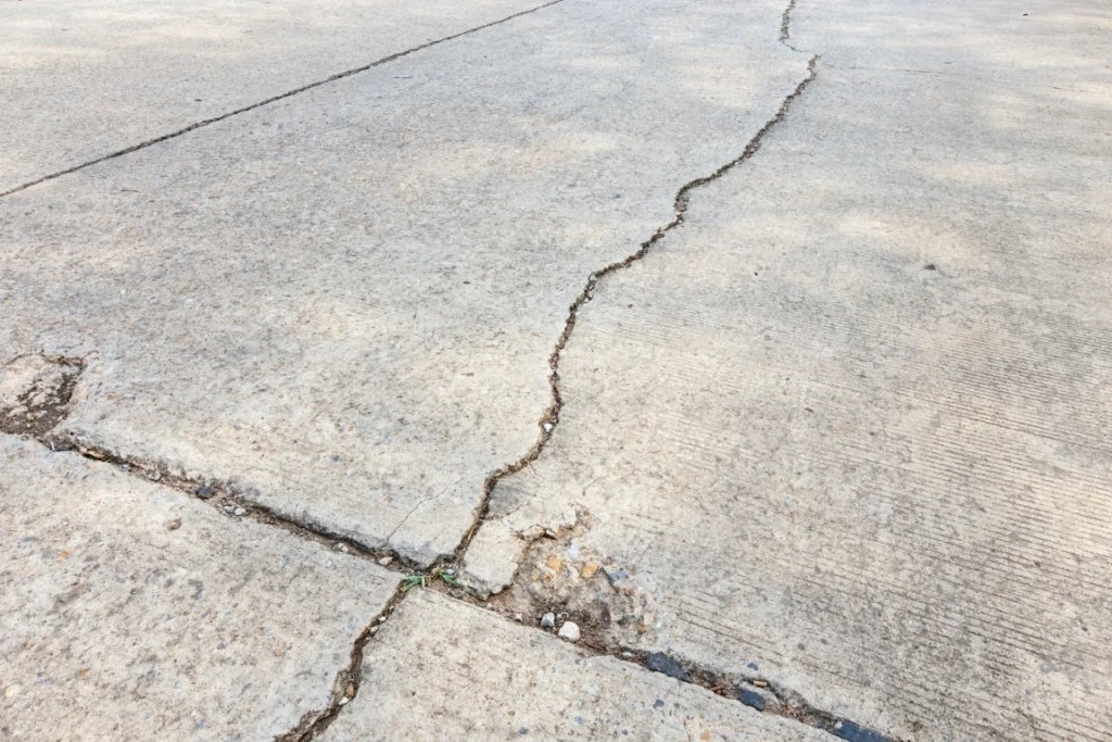 A cracked driveway in Melbourne needing concrete repairs.