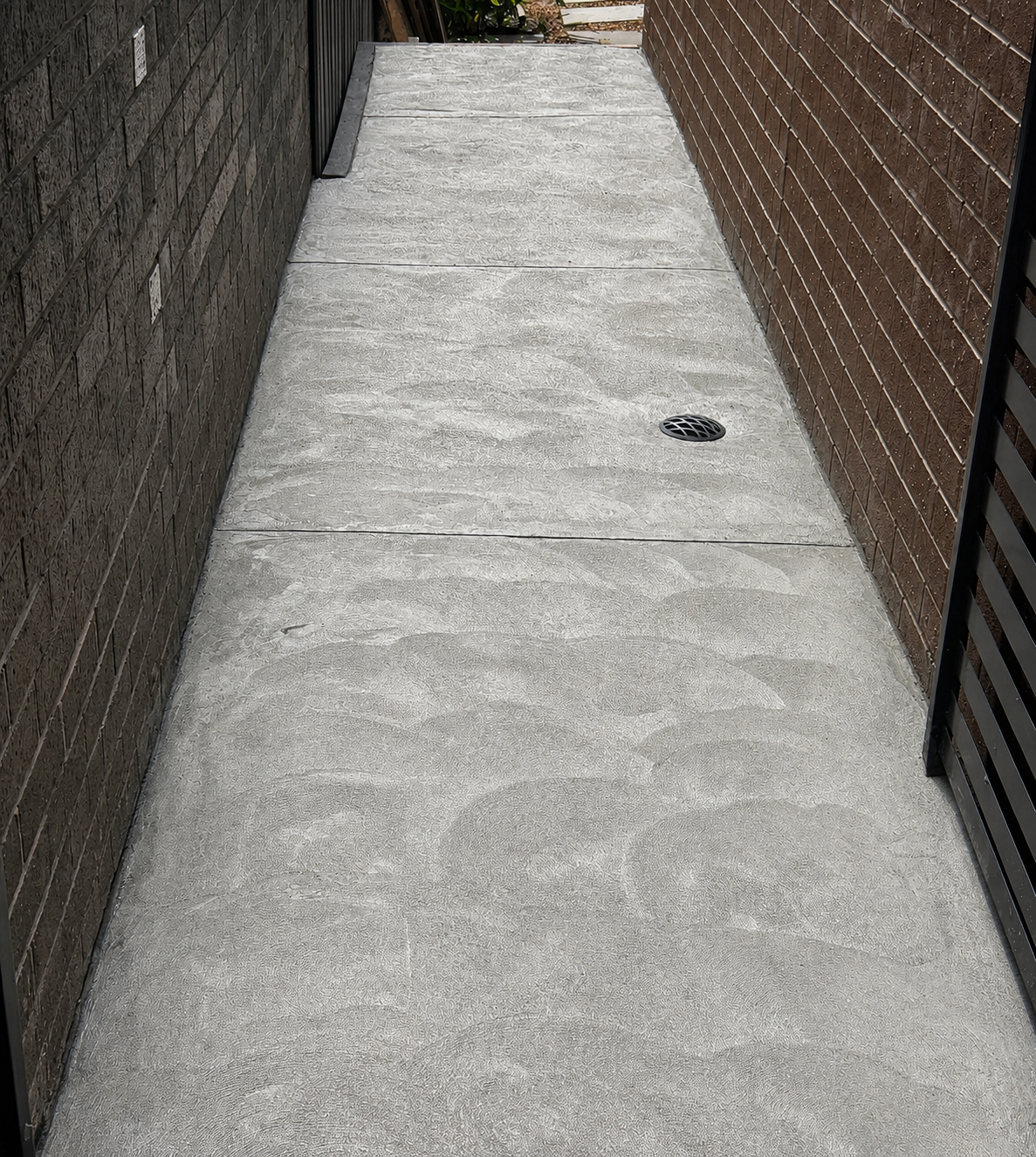 Concrete side path beside a residential property
