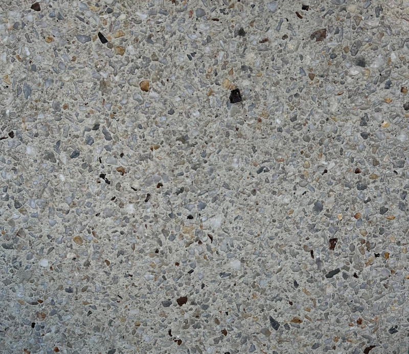 Arctic White exposed aggregate concrete finish with crisp white and pale stone