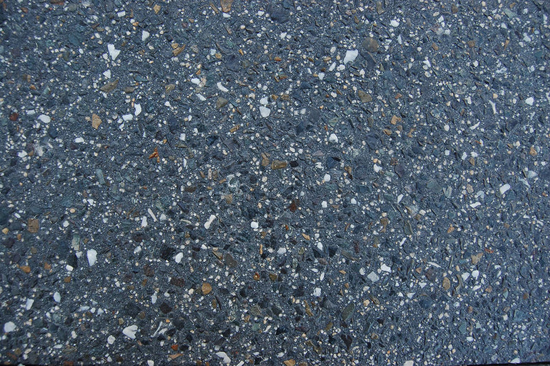 Midnight Quartz exposed aggregate concrete with deep charcoal and black stone