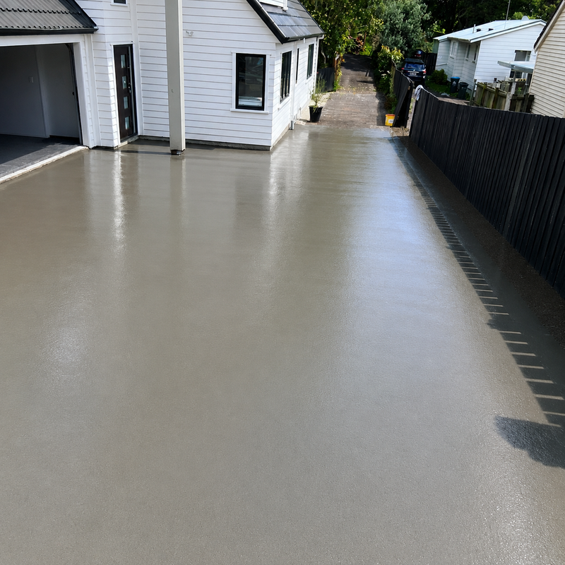 New plain concrete driveway with a smooth finish at a modern Melbourne home.